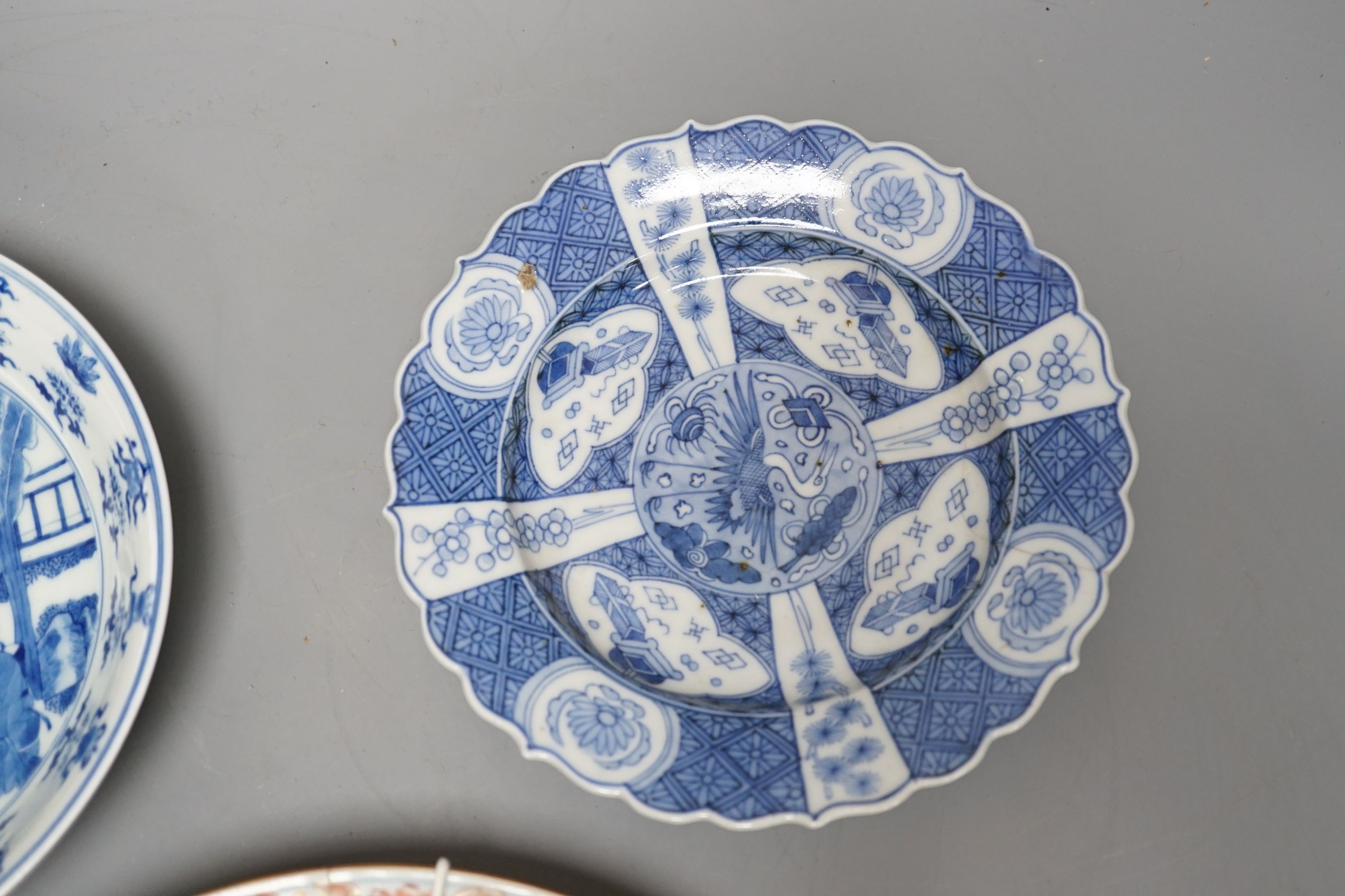 Three Chinese plates including a 19th century Chinese Imari dish, 23cm - repaired, a Chinese famille rose crackleglaze vase, 29cm, together with a famille rose teapot and a crackleglaze celadon ground bottle vase. Talles